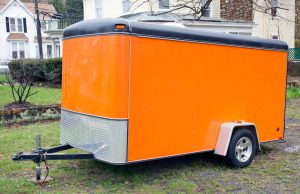 "Orange trailer with hitch. Horizontal.-For more trucks, trailers, and vans, click here."